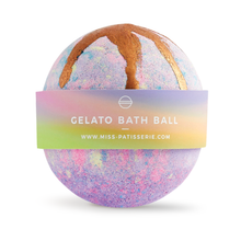Load image into Gallery viewer, Miss Patisserie gelato bath ball. Image shows just the bath ball, which is mainly purple and gold. Vegan and cruelty-free. Available at Lovethical along with plenty of other vegan and cruelty-free beauty products, makeup, make up, toiletries and cosmetics for all your gift and present needs. 
