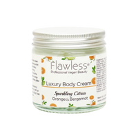 Flawless body cream - sparkling citrus. Image shows a close-up on the product in a glass pot and aluminium lid. Vegan and cruelty-free. Available at Lovethical along with plenty of other vegan and cruelty-free beauty products, makeup, make up, toiletries and cosmetics for all your gift and present needs. 