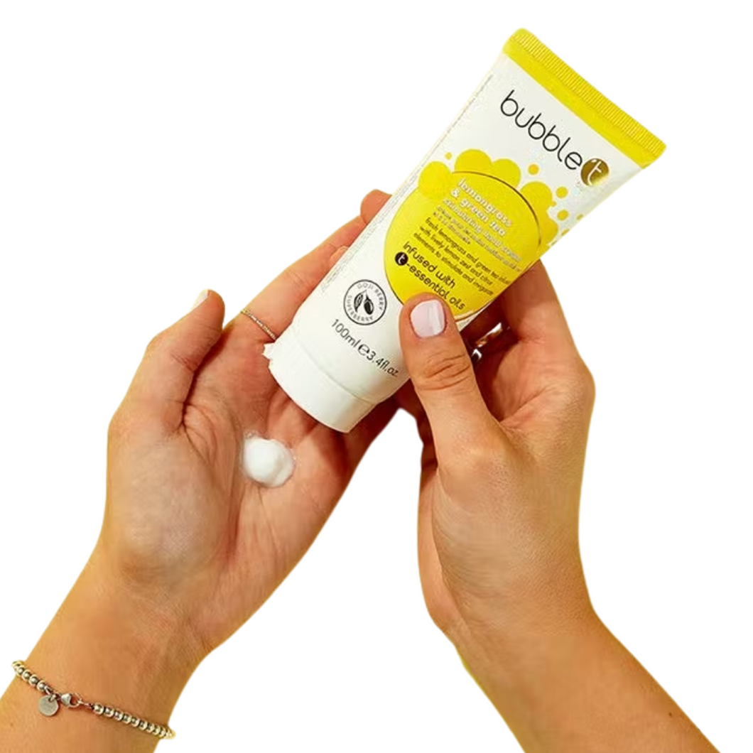 Bubble T Cosmetics lemongrass and green tea hand cream. Image shows someone's hands holding the hand cream in one hand and using it to put some hand cream in the other hand. Vegan and cruelty-free. Available at Lovethical along with plenty of other vegan and cruelty-free beauty products, makeup, make up, toiletries and cosmetics for all your gift and present needs.