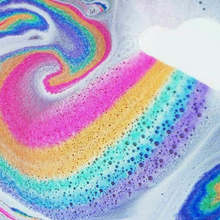 Load image into Gallery viewer, Bubble T Cosmetics rainbow bath art gift set. Image shows the cloud bath bomb in the bath and a beautiful rainbow-coloured effect in the bubbly water around it. Vegan and cruelty-free. Available at Lovethical along with plenty of other vegan and cruelty-free beauty products, makeup, make up, toiletries and cosmetics for all your gift and present needs.

