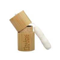Flawless compostable dental floss with bamboo dispenser - peppermint. Image shows the bamboo dispenser and the corn fibre floss alongside it. Vegan and cruelty-free. Available at Lovethical along with plenty of other vegan and cruelty-free beauty products, makeup, make up, toiletries and cosmetics for all your gift and present needs. 