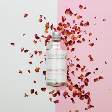 Load image into Gallery viewer, 1 glass bottles of Flawless hydrating toner - rose and lavender - with a grey and pink background and bits of rose petals in the background. Vegan and cruelty-free. Available at Lovethical along with plenty of other vegan and cruelty-free beauty products, makeup, make up, toiletries and cosmetics for all your gift and present needs. 
