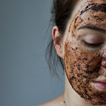 Load image into Gallery viewer, Picture of half a woman&#39;s face covered in UpCircle coffee face scrub. Vegan and cruelty-free. Available at Lovethical along with plenty of other vegan and cruelty-free beauty products, makeup, make up, toiletries and cosmetics for all your gift and present needs. 
