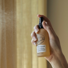 Load image into Gallery viewer, Close up picture of someone spraying UpCircle face toner into the air. Vegan and cruelty-free. Available at Lovethical along with plenty of other vegan and cruelty-free beauty products, makeup, make up, toiletries and cosmetics for all your gift and present needs. 
