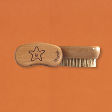 Load image into Gallery viewer, Moonie nail brush. Vegan and cruelty-free. Image shows the nail brush with the image of a smiling starfish on the top. Available at Lovethical along with plenty of other vegan and cruelty-free beauty products, makeup, make up, toiletries and cosmetics for all your gift and present needs. 
