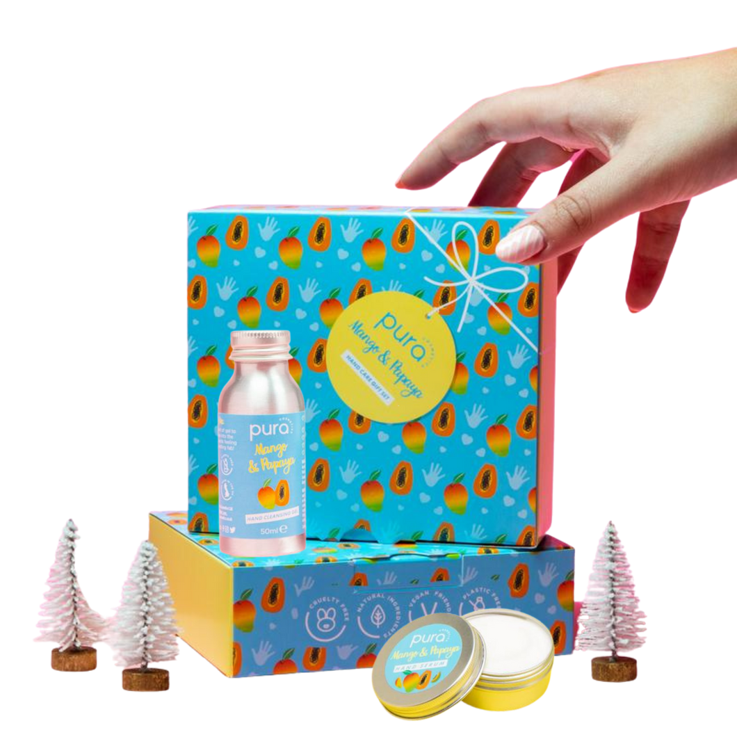 Pura Cosmetics mango and papaya hand care gift set. Vegan and cruelty-free. Image shows the hand sanitiser and the hand cream, along with two of the presentation gift boxes, Available at Lovethical along with plenty of other vegan and cruelty-free beauty products, makeup, make up, toiletries and cosmetics for all your gift and present needs. 