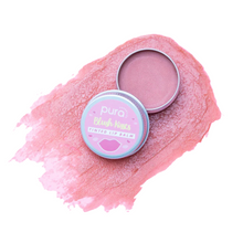 Load image into Gallery viewer, Pura Cosmetics pink tinted lip balm. Vegan and cruelty-free. Image shows the an open tin of lip balm with the vibrant pink pigment neatly smeared behind it. Available at Lovethical along with plenty of other vegan and cruelty-free beauty products, makeup, make up, toiletries and cosmetics for all your gift and present needs. 
