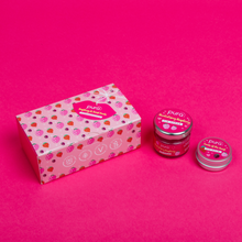 Load image into Gallery viewer, Pura Cosmetics raspberry and forest fruits lip scrub and balm duo gift set. Vegan and cruelty-free. Image shows the products next to a closed gift set box. Available at Lovethical along with plenty of other vegan and cruelty-free beauty products, makeup, make up, toiletries and cosmetics for all your gift and present needs. 
