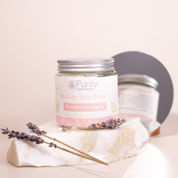 Picture of a pot of Purity's Be Calm Baby Butter on a stone slab, with some lavender placed on the stone. Vegan and cruelty-free. Available at Lovethical along with plenty of other vegan and cruelty-free beauty products, makeup, make up, toiletries and cosmetics for all your gift and present needs. 
