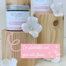 Load image into Gallery viewer, Picture of two pots of Purity&#39;s Clear Skin Cream on wooden stands, with a sign saying &#39;I&#39;m plantable and turn into flowers&#39;. Vegan and cruelty-free. Available at Lovethical along with plenty of other vegan and cruelty-free beauty products, makeup, make up, toiletries and cosmetics for all your gift and present needs. 
