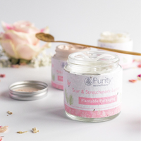 Beautiful picture of an open pot of Purity's Scar and Stretchmark Lotion with flowers in the background. Vegan and cruelty-free. Available at Lovethical along with plenty of other vegan and cruelty-free beauty products, makeup, make up, toiletries and cosmetics for all your gift and present needs. 
