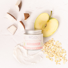 Load image into Gallery viewer, Picture taken from above of a pot of Purity&#39;s youth glow face cream alongside half an apple, some rolled oats, some coconut pieces and a sample of the face cream delicately smeared there too. Vegan and cruelty-free. Available at Lovethical along with plenty of other vegan and cruelty-free beauty products, makeup, make up, toiletries and cosmetics for all your gift and present needs. 
