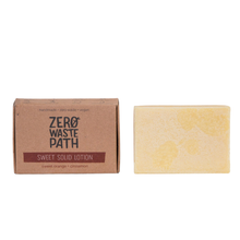 Load image into Gallery viewer, Zero Waste Path sweet solid lotion with white background. Vegan and cruelty-free. Available at Lovethical along with plenty of other vegan and cruelty-free beauty products, makeup, make up, toiletries and cosmetics for all your gift and present needs. 
