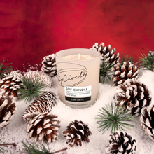 Load image into Gallery viewer, UpCircle chai latte soy wax candle. Vegan and cruelty-free. Image shows the candle surrounded by Christmas pine cones and snow.
