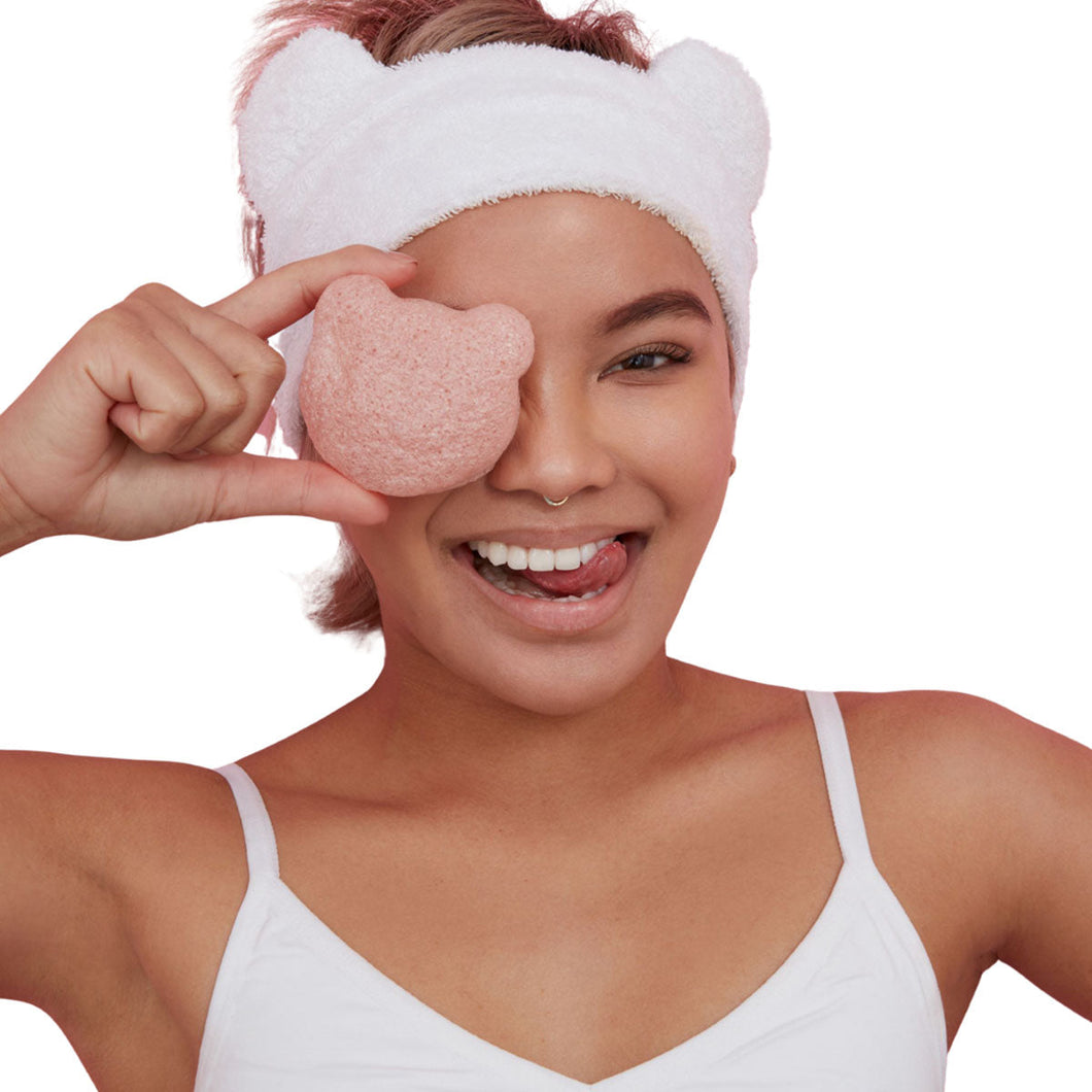 Bear Beauty Botanicals cherry infused konjac sponge. Image shows a woman holding the konjac spinge to her face. Vegan and cruelty-free. Available at Lovethical along with plenty of other vegan and cruelty-free beauty products, makeup, make up, toiletries and cosmetics for all your gift and present needs. 