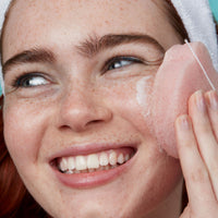 Bear Beauty Botanicals cherry infused konjac sponge. Image shows a woman using the konjac sponge on her face. Vegan and cruelty-free. Available at Lovethical along with plenty of other vegan and cruelty-free beauty products, makeup, make up, toiletries and cosmetics for all your gift and present needs. 