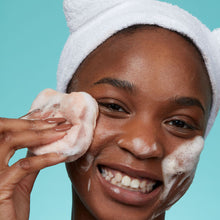 Load image into Gallery viewer, Bear Beauty Botanicals cherry infused konjac sponge. Image shows a woman using the konjac sponge on her face. Vegan and cruelty-free. Available at Lovethical along with plenty of other vegan and cruelty-free beauty products, makeup, make up, toiletries and cosmetics for all your gift and present needs. 
