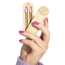 Load image into Gallery viewer, Bear Beauty Botanicals reusable silicone q-tips. Vegan and cruelty-free. Image shows a close up of someone holding the q-tips in their bamboo case. Available at Lovethical along with plenty of other vegan and cruelty-free beauty products, makeup, make up, toiletries and cosmetics for all your gift and present needs. 
