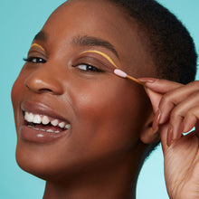 Load image into Gallery viewer, Bear Beauty Botanicals reusable silicone q-tips. Vegan and cruelty-free. Image shows a woman using the q-tips to correct their eye makeup. Available at Lovethical along with plenty of other vegan and cruelty-free beauty products, makeup, make up, toiletries and cosmetics for all your gift and present needs. 
