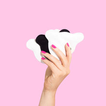 Load image into Gallery viewer, Bear Beauty Botanicals reusable bamboo and cotton makeup pads. Vegan and cruelty-free. Image shows someone holding up two white and one black pads. Available at Lovethical along with plenty of other vegan and cruelty-free beauty products, makeup, make up, toiletries and cosmetics for all your gift and present needs. 

