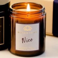 Bloomtown nice candle - almond and rose. Vegan and cruelty-free. Image shows the lit candle. Available at Lovethical along with plenty of other vegan and cruelty-free beauty products, makeup, make up, toiletries and cosmetics for all your gift and present needs. 
