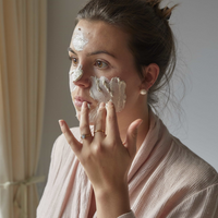 UpCircle face mask. Vegan and cruelty-free. Image shows a woman putting the face mask on her skin.