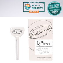 Load image into Gallery viewer, UpCircle tube squeezer key. Vegan and cruelty-free. Image shows the key with 2 awards listed above it.
