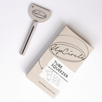 UpCircle tube squeezer key. Vegan and cruelty-free. Image shows the key in and out of its box.