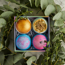 Load image into Gallery viewer, Miss Patisserie Great Balls of Fizz bath ball gift set. Contains four bath balls. Picture shows all four in a lovely gift box, surrounded by lots of lovely green foliage. Vegan and cruelty-free. Available at Lovethical along with plenty of other vegan and cruelty-free beauty products, makeup, make up, toiletries and cosmetics for all your gift and present needs. 
