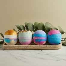 Load image into Gallery viewer, Miss Patisserie Great Balls of Fizz bath ball gift set. Contains four bath balls. Picture shows all four next to each other, surrounded by lots of lovely green foliage. Vegan and cruelty-free. Available at Lovethical along with plenty of other vegan and cruelty-free beauty products, makeup, make up, toiletries and cosmetics for all your gift and present needs. 
