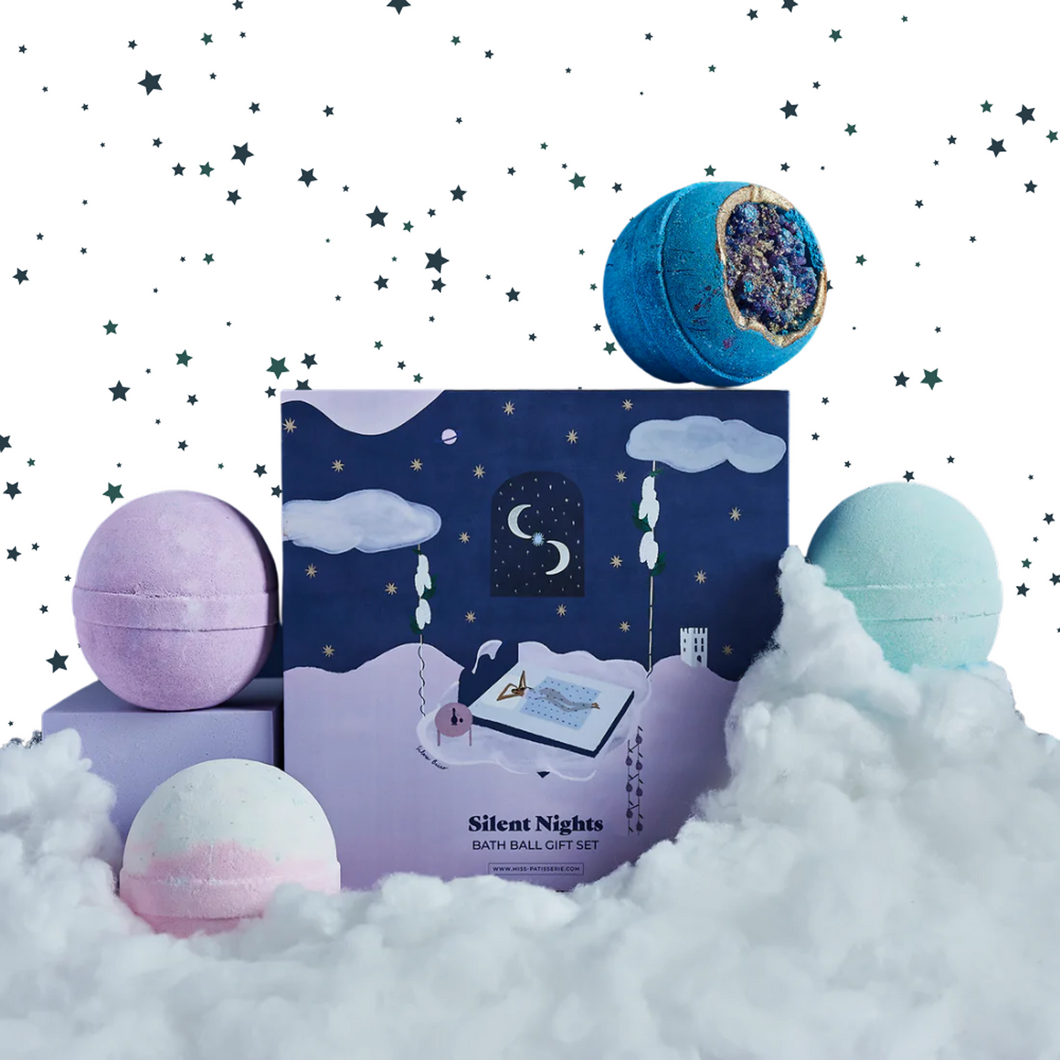 Miss Patisserie Silent Nights bath bomb gift set. Picture shows the gift set surrounded by clouds and stars. Vegan and cruelty-free. Available at Lovethical along with plenty of other vegan and cruelty-free beauty products, makeup, make up, toiletries and cosmetics for all your gift and present needs. 