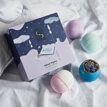 Load image into Gallery viewer, Miss Patisserie Silent Nights bath bomb gift set. Picture shows the gift set resting on bed sheets. Vegan and cruelty-free. Available at Lovethical along with plenty of other vegan and cruelty-free beauty products, makeup, make up, toiletries and cosmetics for all your gift and present needs. 
